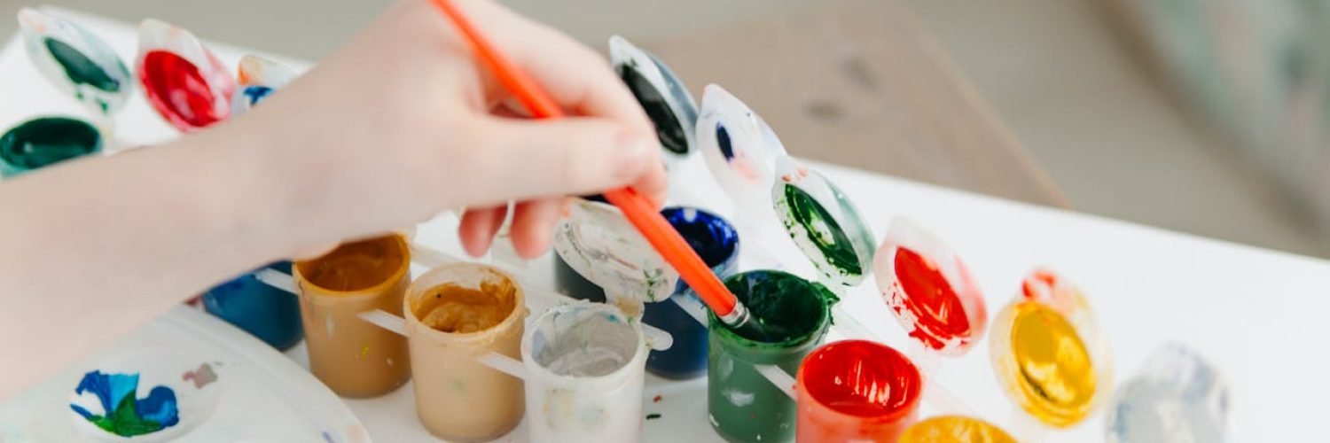 pexels-photo-6966323 A child paints using a colorful watercolor palette, fostering creativity and fun.